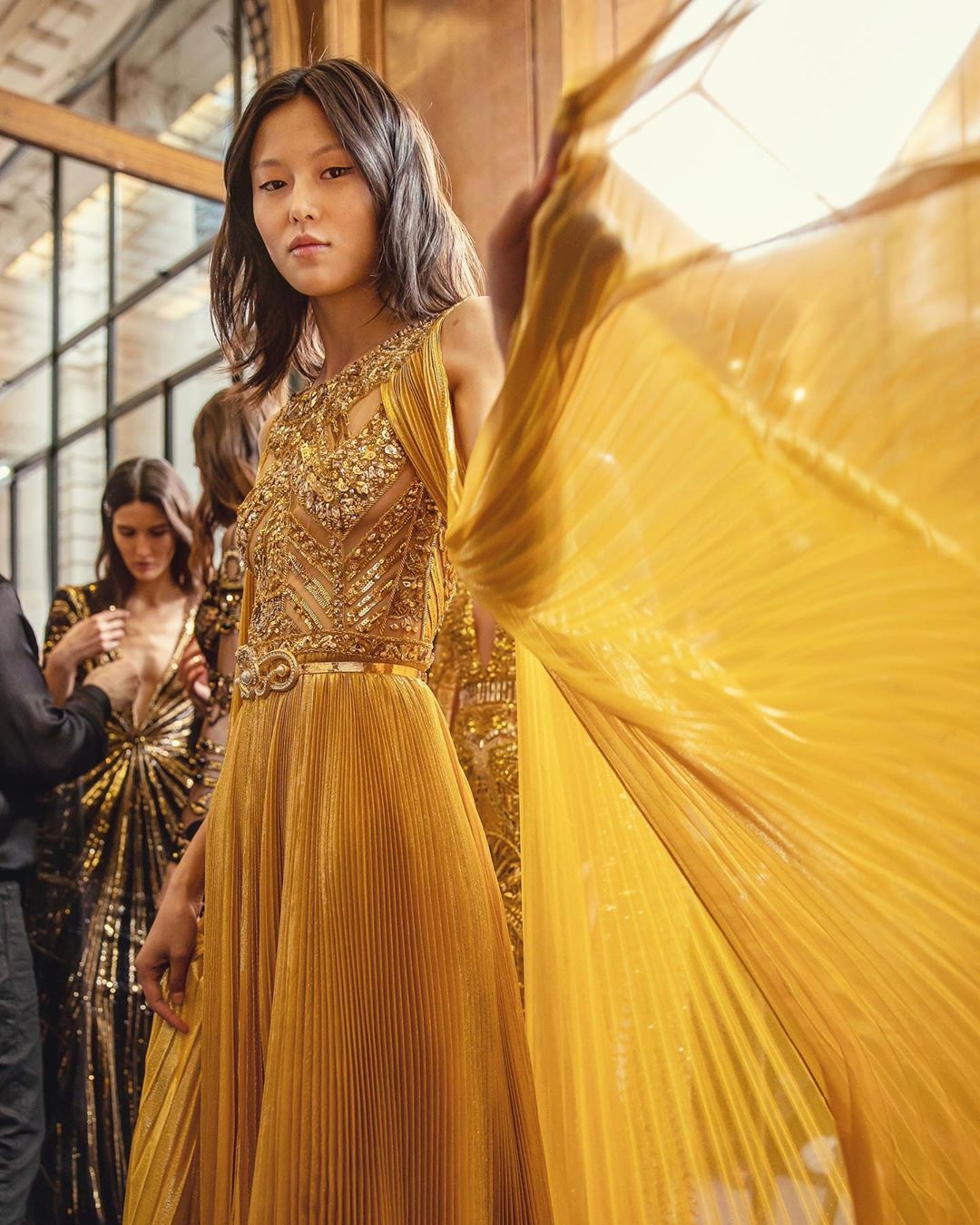 Gold Sleeveless Sequin Long Gown with Intricate Bodice and Pleated Organza.