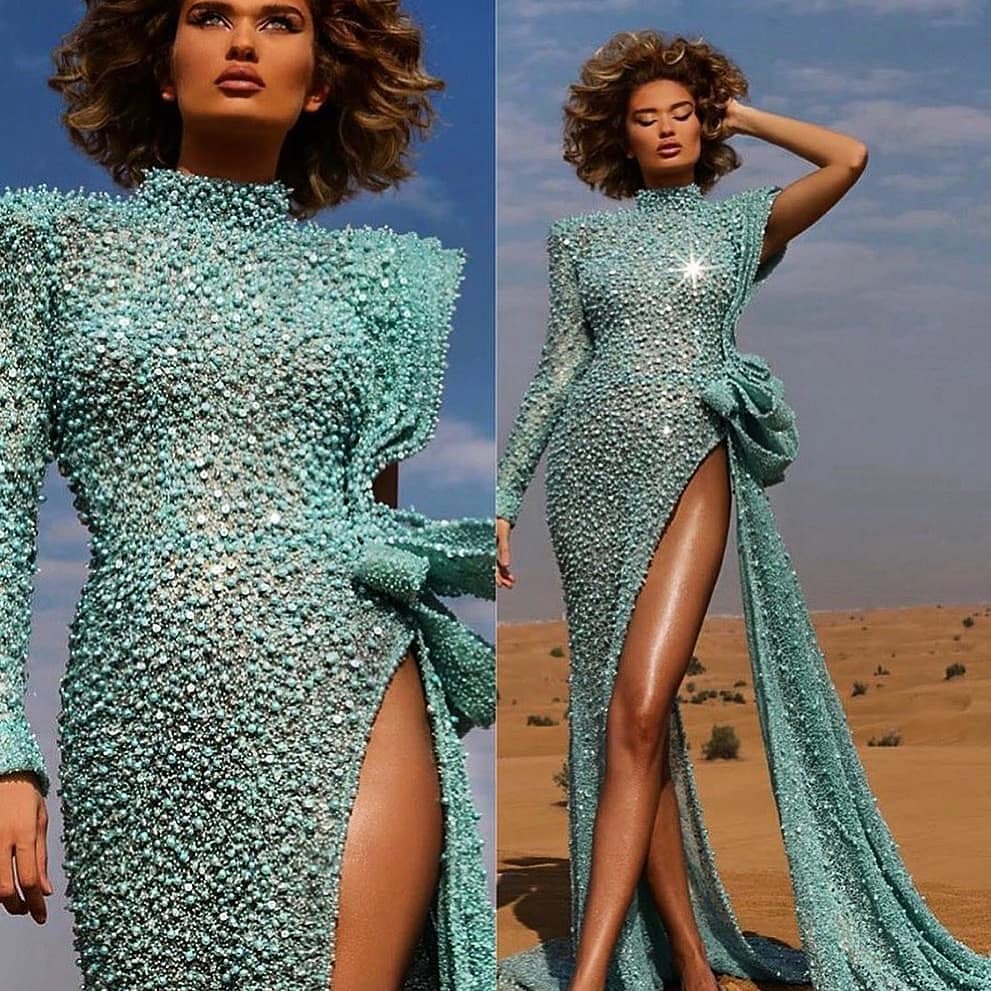 Turquoise Couture Crystal and Beaded Gown with High Slit, Rouched Bow and Single Sleeve. The best bling online.