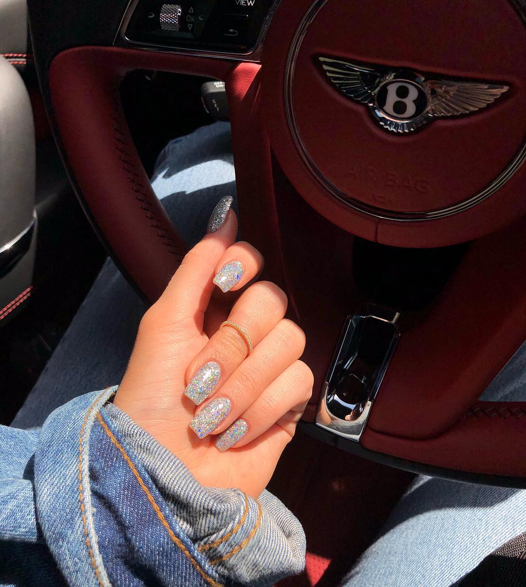 Kylie Jenner In Her Bentley with Her Nails Bling