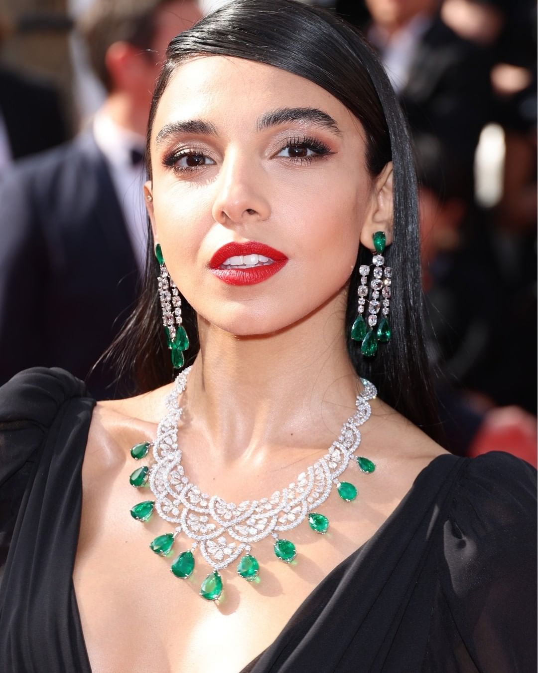 Salma Abu-Deif Wearing A Diamond Neck Choker with Emerald Stones and Matching Hanging Earrings