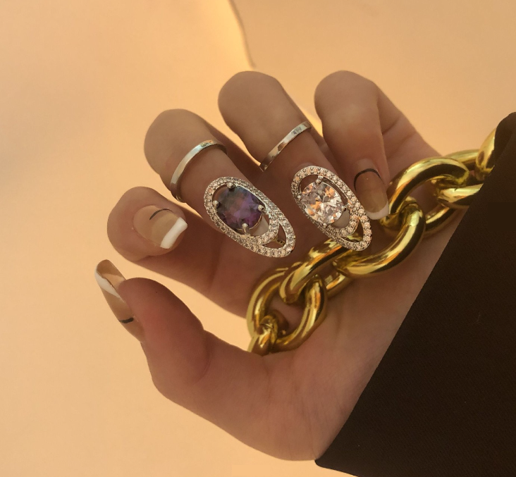 A Pair Of Nail Rings with Glittering Rhinestones and 2 Crystals In the Middle